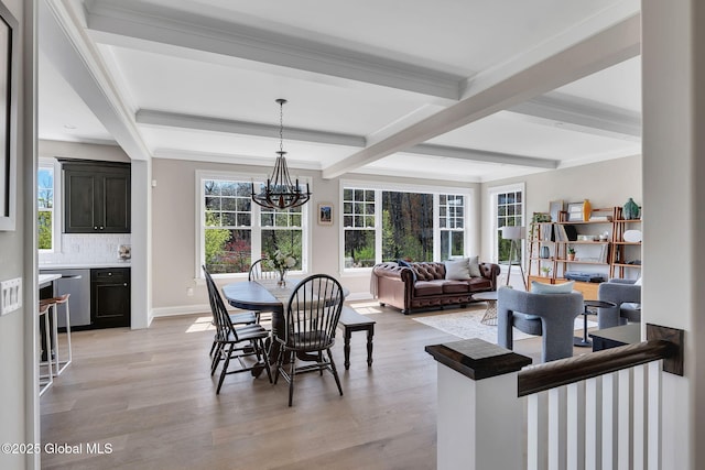 dining room with light wood finished floors, beamed ceiling, baseboards, and a notable chandelier