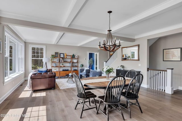 dining room with an inviting chandelier, light wood-type flooring, baseboards, and beam ceiling