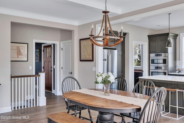 dining area with baseboards, ornamental molding, and wood finished floors