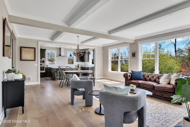 living room with light wood-style floors, baseboards, visible vents, and beam ceiling