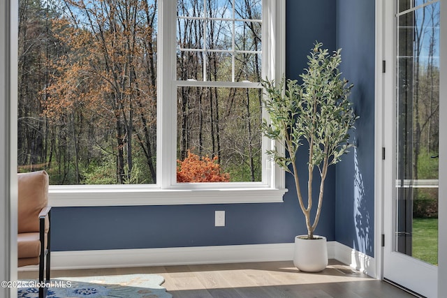 interior space with wood finished floors and baseboards