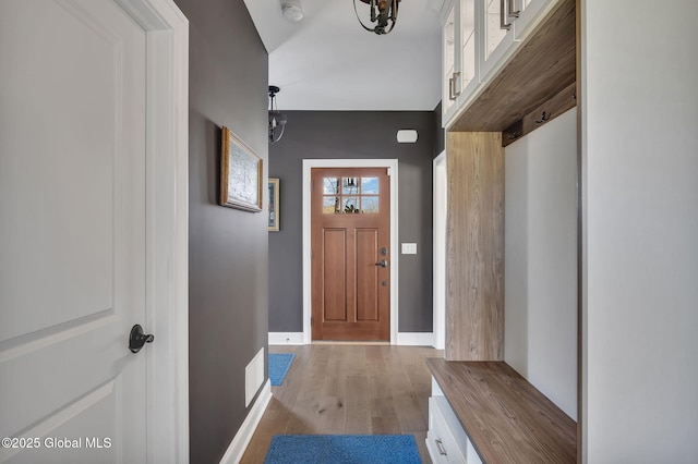 mudroom with baseboards and wood finished floors