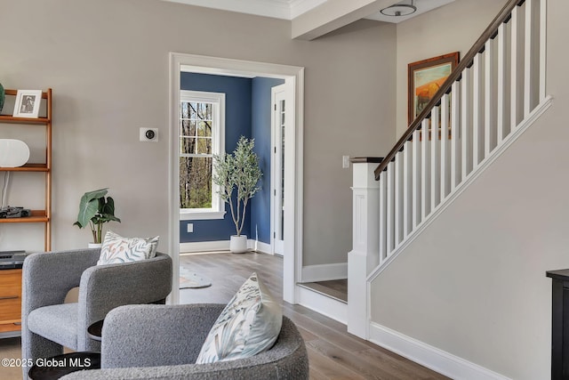 foyer entrance featuring stairs, baseboards, and wood finished floors