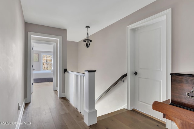 stairway featuring baseboards and wood finished floors