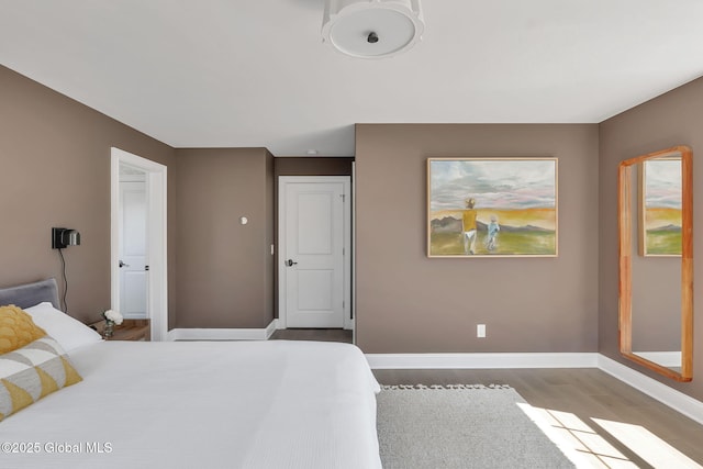 bedroom featuring wood finished floors and baseboards