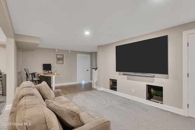 living room with baseboards and recessed lighting