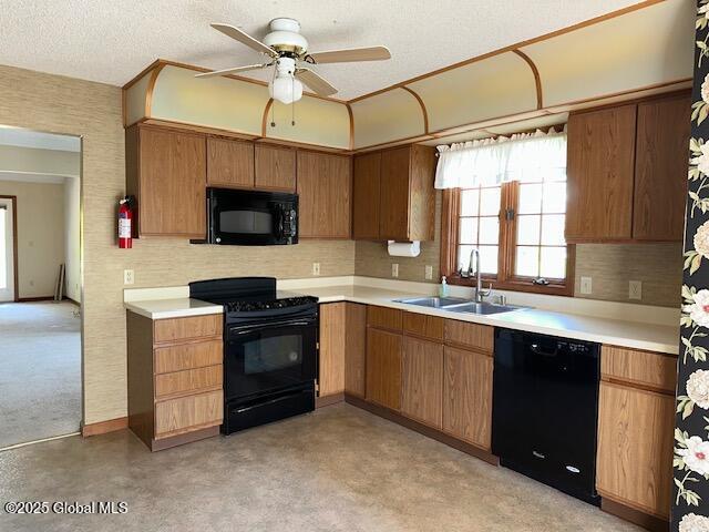 kitchen with a ceiling fan, light countertops, tasteful backsplash, a sink, and black appliances