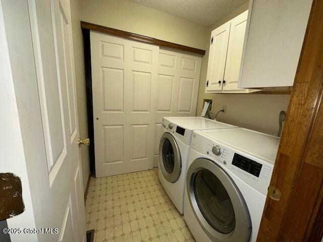 laundry area featuring light floors, visible vents, cabinet space, and washer and dryer