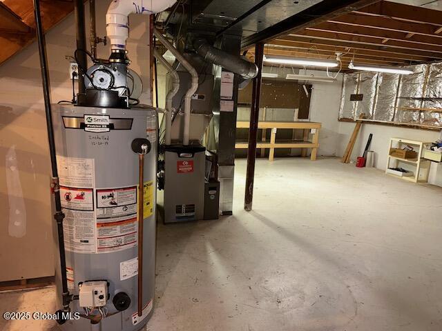 utility room featuring heating unit and water heater