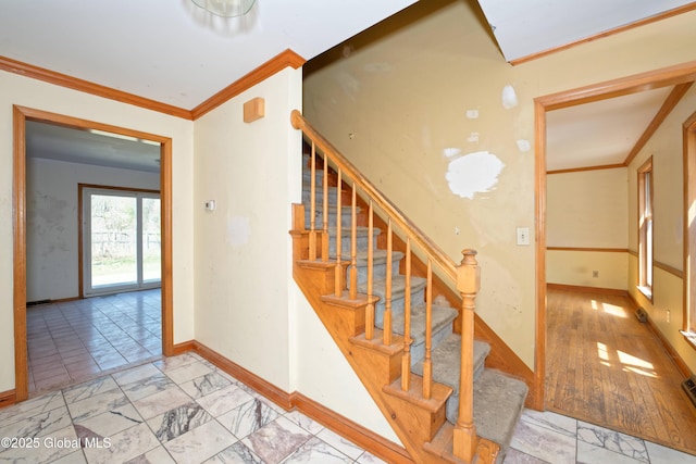 staircase featuring baseboards, marble finish floor, and crown molding
