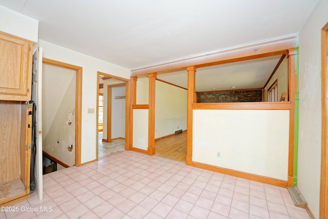 spare room with baseboards