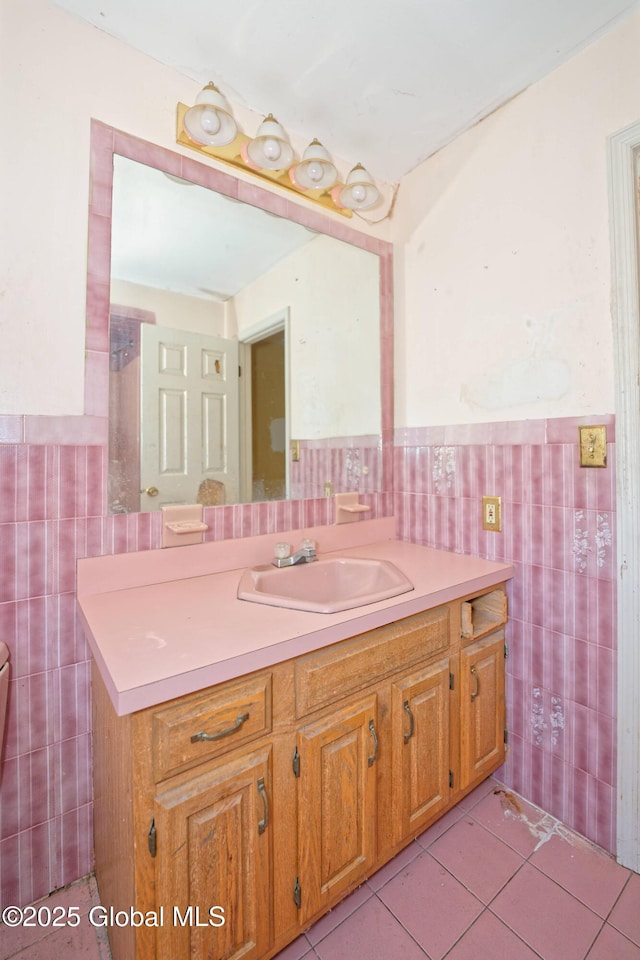 bathroom featuring tile patterned floors, tile walls, wainscoting, and vanity