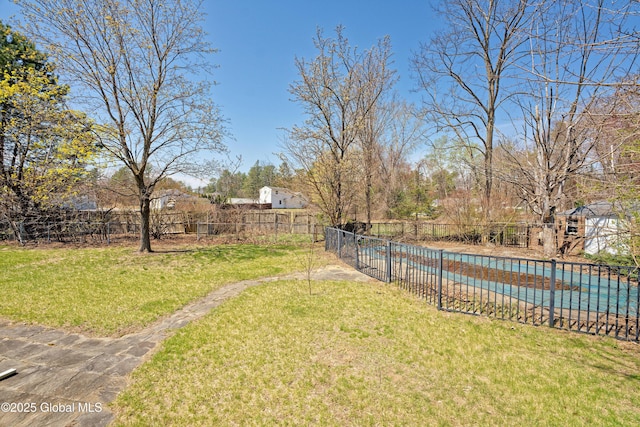 view of yard with fence and a fenced in pool