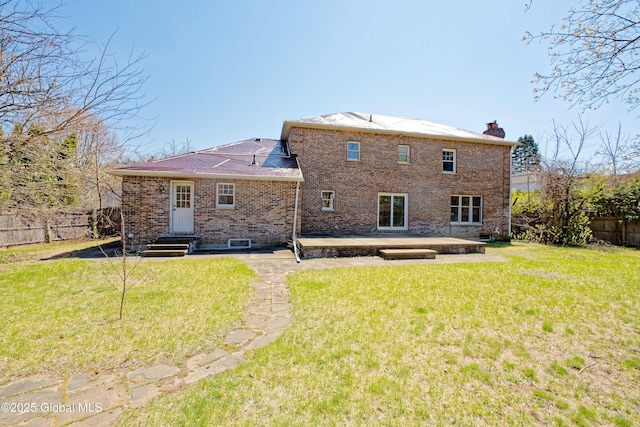 rear view of property featuring a patio, fence, a yard, and brick siding