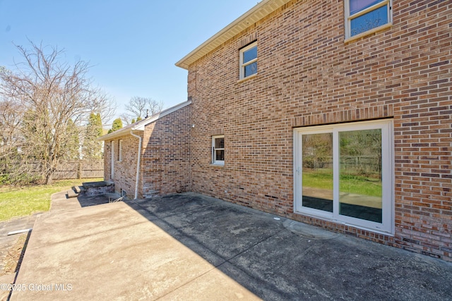 view of home's exterior featuring a patio and brick siding