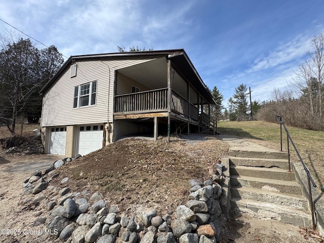view of front of house featuring stairway and a garage