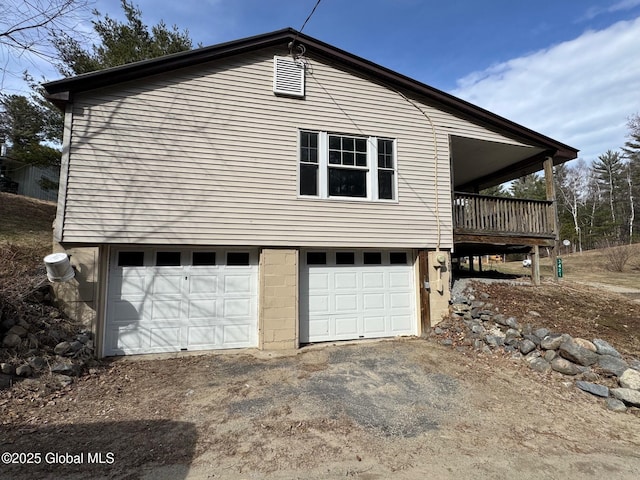 view of property exterior featuring driveway and a garage
