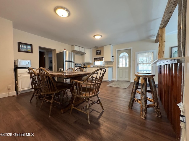 dining room with dark wood-style flooring and baseboards