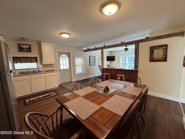 dining area with baseboards, ceiling fan, dark wood-type flooring, and plenty of natural light