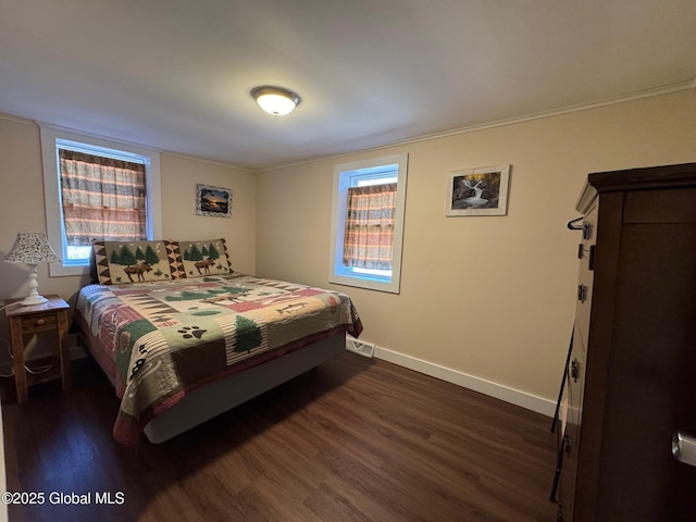 bedroom featuring dark wood finished floors, baseboards, and crown molding