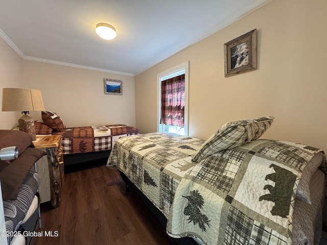 bedroom with dark wood finished floors and ornamental molding