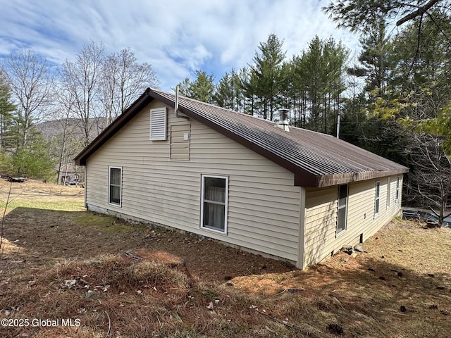 view of side of property featuring metal roof