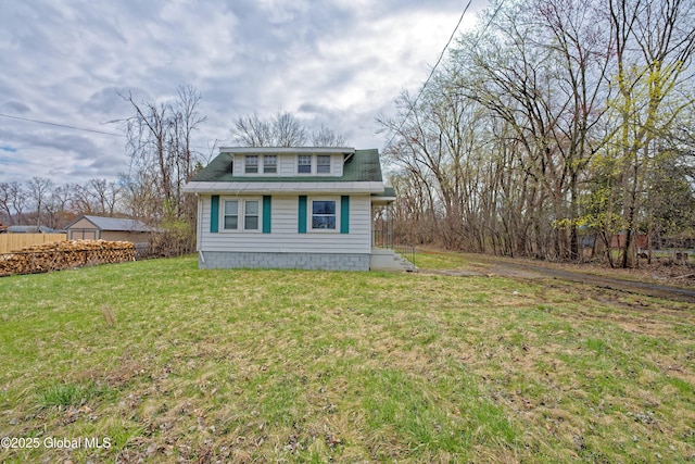 view of property exterior with fence and a lawn