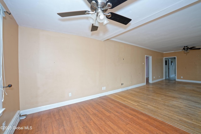 empty room with baseboards, wood finished floors, a ceiling fan, and crown molding