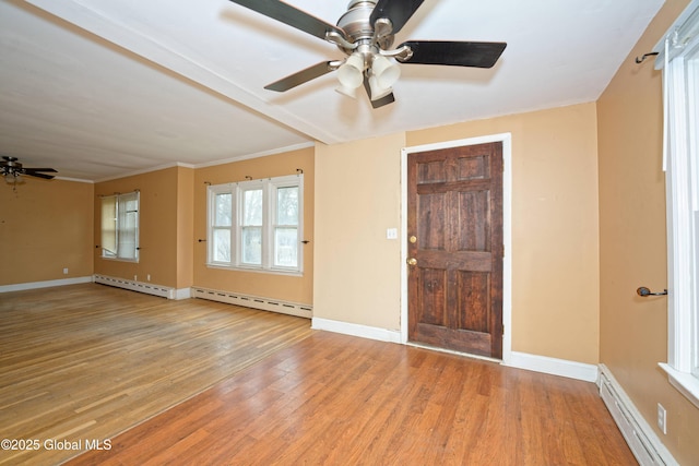 foyer entrance featuring a baseboard heating unit, light wood-style floors, ceiling fan, crown molding, and baseboard heating