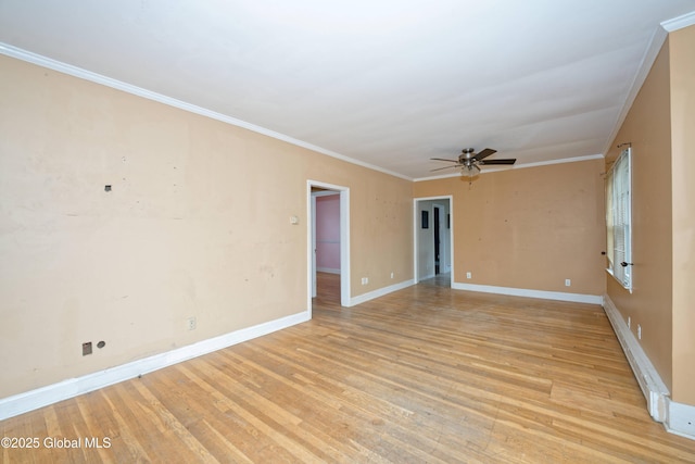 spare room featuring light wood-style flooring, a baseboard radiator, baseboards, a ceiling fan, and crown molding