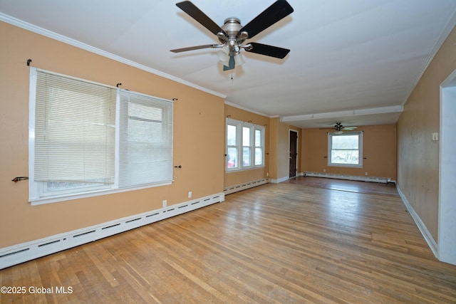empty room featuring baseboard heating, wood finished floors, ceiling fan, and a baseboard radiator