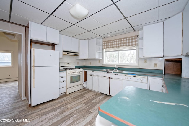 kitchen with a sink, under cabinet range hood, open shelves, white cabinetry, and white appliances