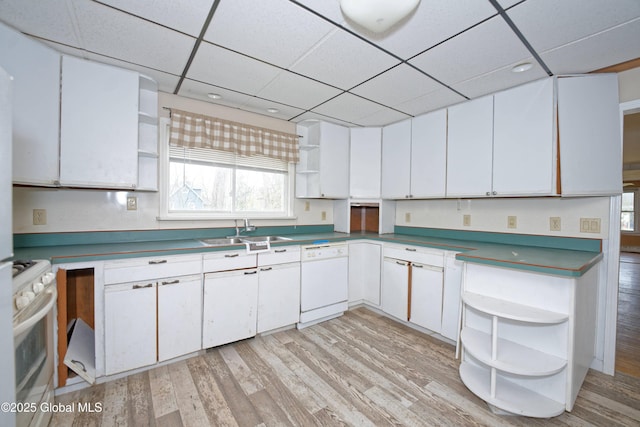 kitchen featuring a sink, open shelves, a wealth of natural light, and white appliances