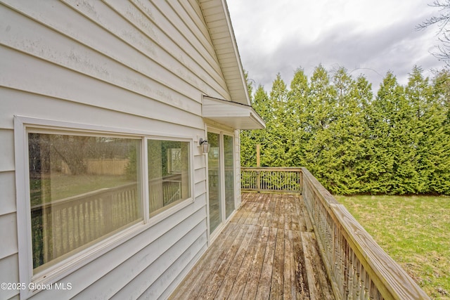 wooden terrace featuring a yard