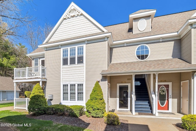 view of front of house featuring a shingled roof and covered porch