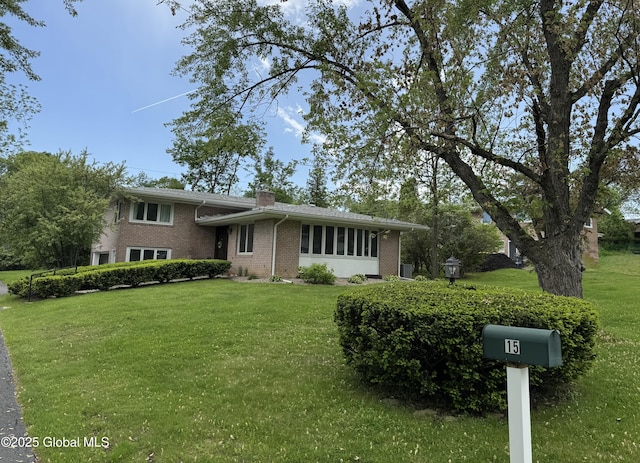 15 Campus View Dr, Colonie, NY 12211 - tri-level home with brick siding, a front yard, and a chimney