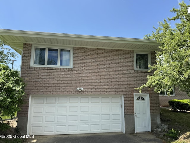 15 Campus View Dr, Colonie, NY 12211 - view of home's exterior featuring brick siding, asphalt driveway, and a garage