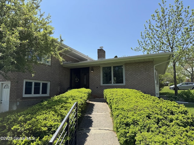 15 Campus View Dr, Colonie, NY 12211 - split level home with a chimney and brick siding
