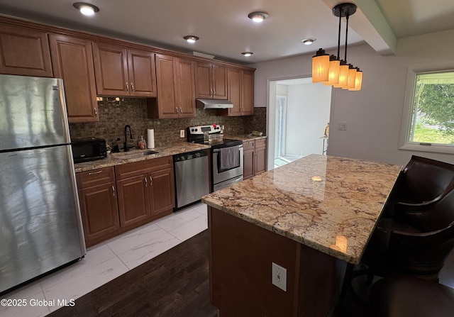 15 Campus View Dr, Colonie, NY 12211 - kitchen with stainless steel appliances, a sink, under cabinet range hood, decorative backsplash, and light stone counters