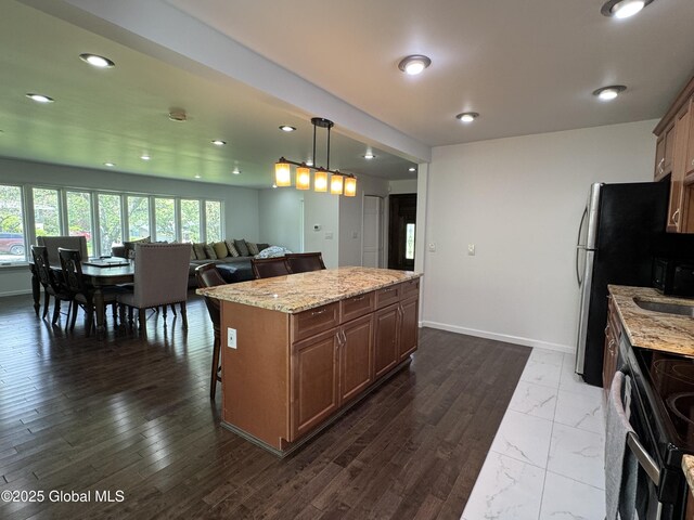 15 Campus View Dr, Colonie, NY 12211 - kitchen with black electric range, a center island, light stone counters, baseboards, and pendant lighting