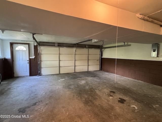 15 Campus View Dr, Colonie, NY 12211 - garage featuring a garage door opener, electric panel, and concrete block wall