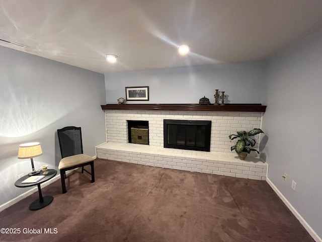 unfurnished living room with a brick fireplace, baseboards, visible vents, and carpet