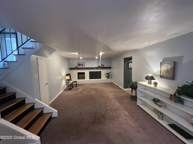 living area with baseboards, carpet flooring, stairs, and a brick fireplace