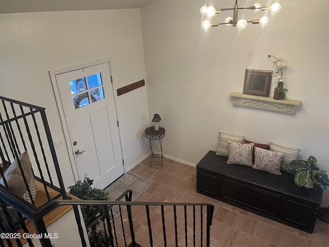 foyer entrance featuring baseboards and a notable chandelier