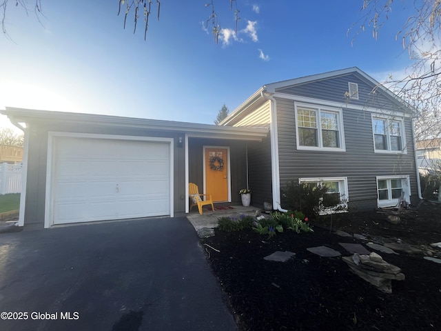 split level home featuring an attached garage and driveway