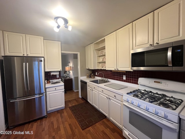 kitchen with open shelves, a sink, light countertops, white cabinets, and stainless steel appliances