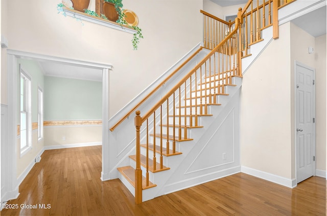 23 Jarose Pl, Clifton Park, NY 12065 - staircase featuring wood finished floors, baseboards, and a towering ceiling