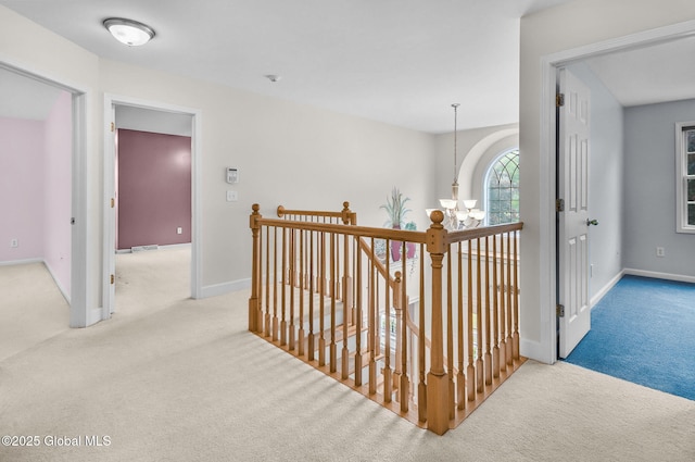 23 Jarose Pl, Clifton Park, NY 12065 - corridor with carpet flooring, an upstairs landing, a chandelier, and baseboards