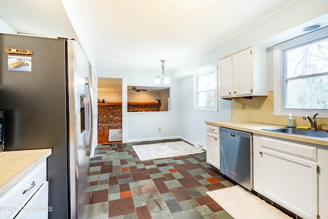 kitchen with baseboards, white cabinets, stainless steel appliances, and dark floors