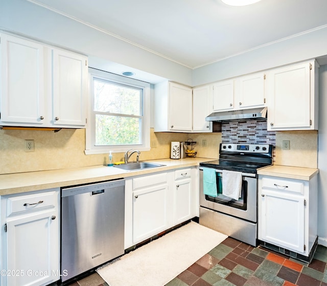 kitchen with a sink, appliances with stainless steel finishes, under cabinet range hood, and white cabinetry
